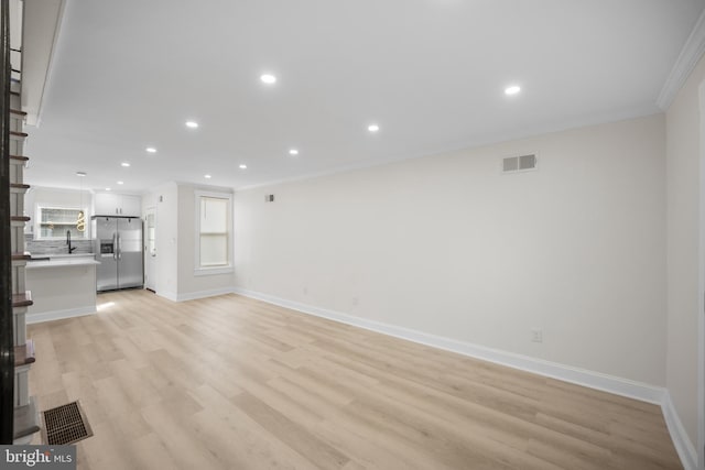 7726 Temple Rd, Philadelphia, PA 19150 - unfurnished living room with crown molding, light wood-type flooring, and recessed lighting
