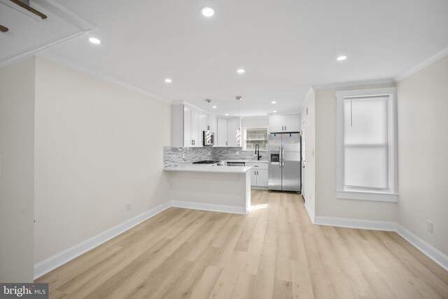 7726 Temple Rd, Philadelphia, PA 19150 - kitchen featuring appliances with stainless steel finishes, crown molding, light wood-style floors, a peninsula, and light countertops