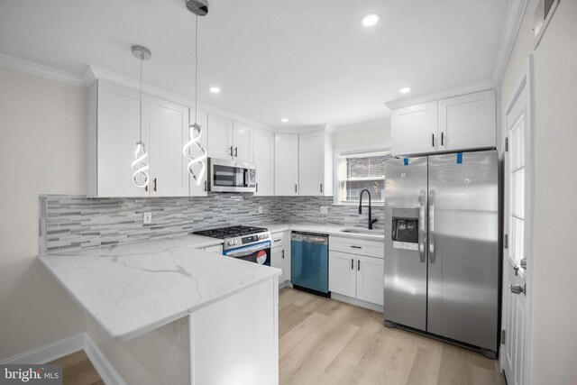 7726 Temple Rd, Philadelphia, PA 19150 - kitchen with stainless steel appliances, crown molding, a peninsula, white cabinets, and light stone countertops