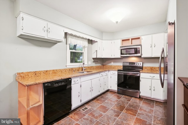 90 Scotts Cove Rd, Edgewater, MD 21037 - kitchen with appliances with stainless steel finishes, white cabinetry, stone finish floors, open shelves, and light stone counters
