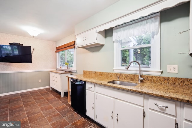 90 Scotts Cove Rd, Edgewater, MD 21037 - kitchen featuring black dishwasher, a wainscoted wall, white cabinets, and light stone counters