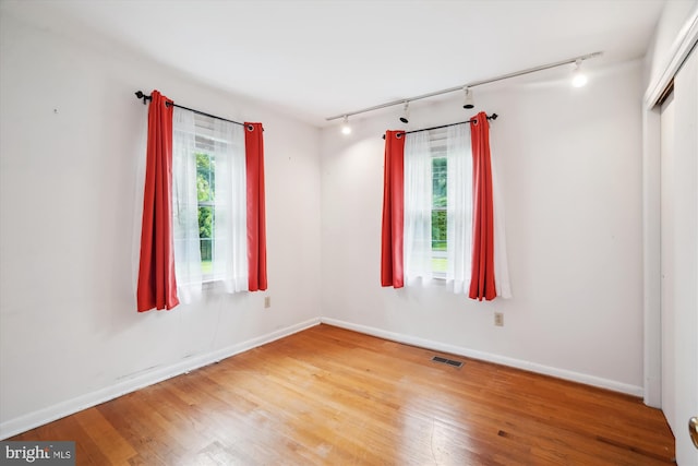 90 Scotts Cove Rd, Edgewater, MD 21037 - spare room with rail lighting, plenty of natural light, and wood finished floors