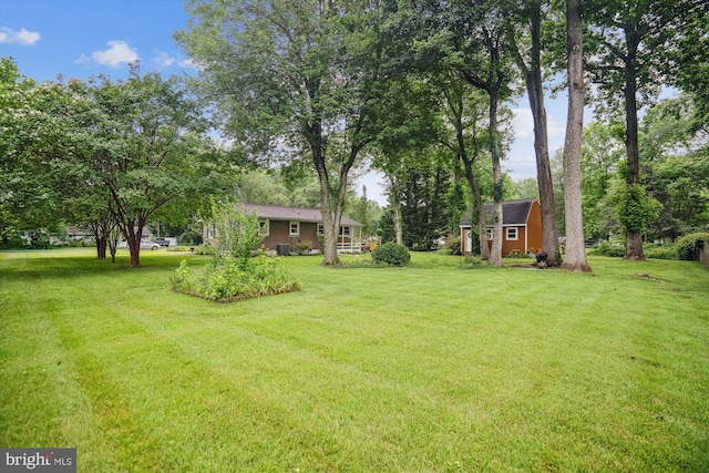 90 Scotts Cove Rd, Edgewater, MD 21037 - view of grassy yard featuring an outdoor structure and view of wooded area