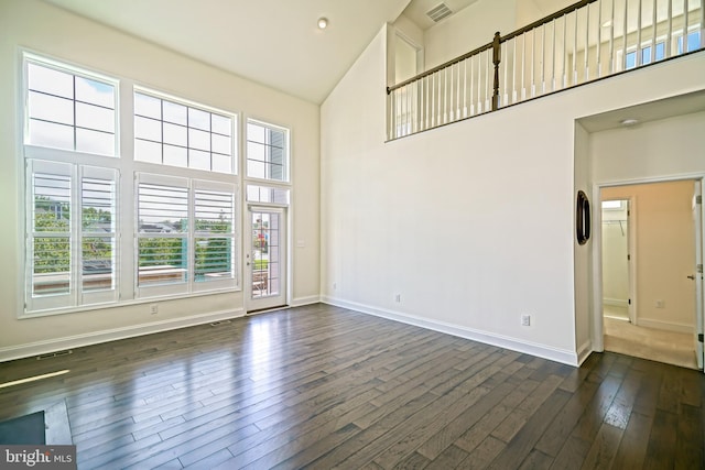 11454 Maull Rd, Lewes, DE 19958 - empty room with high vaulted ceiling, healthy amount of natural light, and dark wood-style flooring