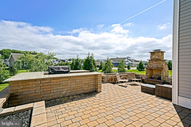 11454 Maull Rd, Lewes, DE 19958 - view of patio / terrace featuring an outdoor stone fireplace, a residential view, and an outdoor kitchen