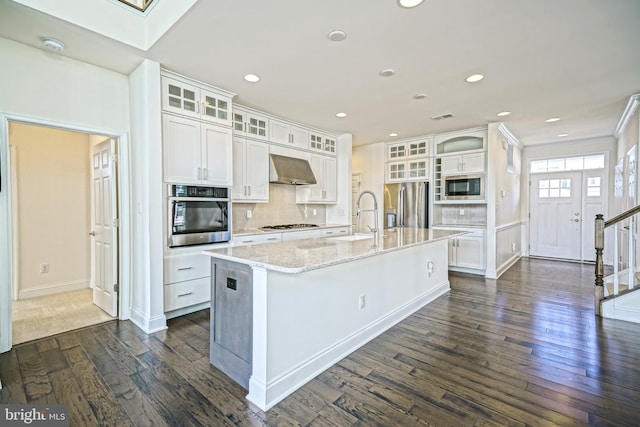 11454 Maull Rd, Lewes, DE 19958 - kitchen featuring stainless steel appliances, extractor fan, dark wood-type flooring, white cabinetry, and recessed lighting