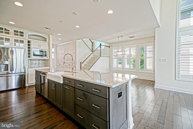11454 Maull Rd, Lewes, DE 19958 - kitchen featuring stainless steel appliances, dark wood-style flooring, white cabinets, recessed lighting, and light stone countertops