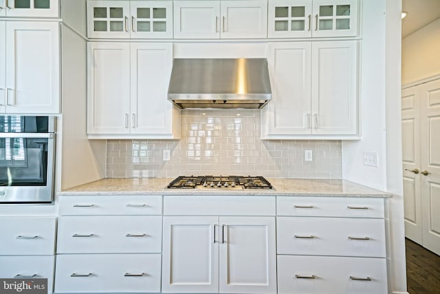 11454 Maull Rd, Lewes, DE 19958 - kitchen with extractor fan, stainless steel appliances, white cabinetry, and glass insert cabinets