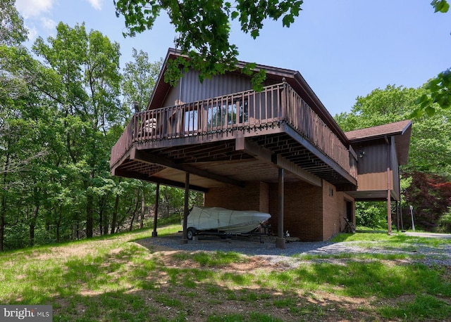 312 Skyline Dr, Reading, PA 19606 - back of property featuring a wooden deck, a carport, and board and batten siding