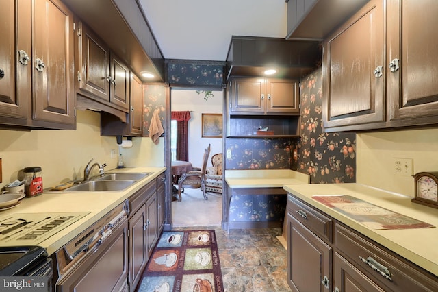 312 Skyline Dr, Reading, PA 19606 - kitchen featuring wallpapered walls, light countertops, dark brown cabinetry, and black stove