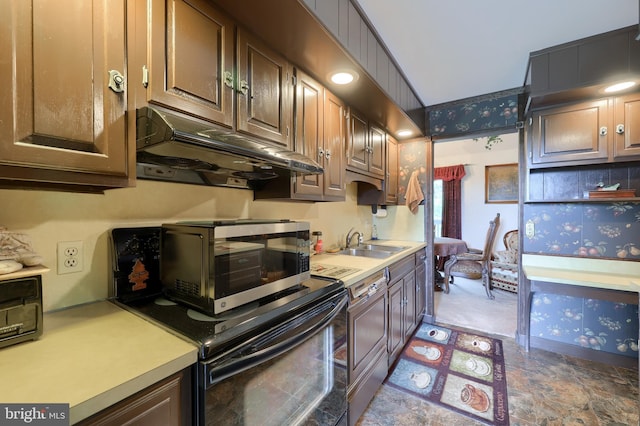 312 Skyline Dr, Reading, PA 19606 - kitchen with under cabinet range hood, light countertops, black range, and wallpapered walls