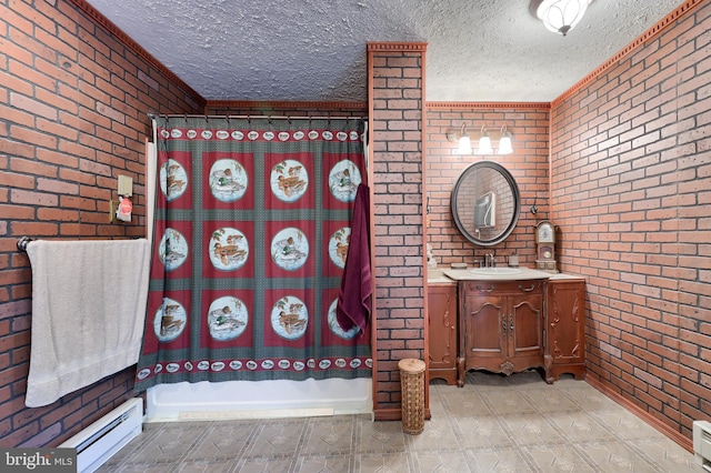 312 Skyline Dr, Reading, PA 19606 - bathroom featuring brick wall, a baseboard heating unit, a textured ceiling, and vanity