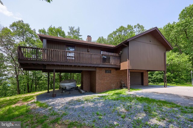 312 Skyline Dr, Reading, PA 19606 - view of front of property with a garage, asphalt driveway, a chimney, brick siding, and a deck