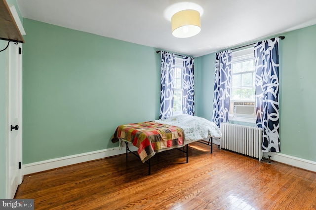 2416 Whitby Rd, Havertown, PA 19083 - bedroom with radiator heating unit, cooling unit, and wood finished floors