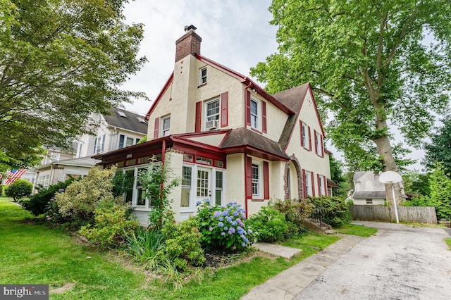 2416 Whitby Rd, Havertown, PA 19083 - view of home's exterior featuring stucco siding, a chimney, and asphalt driveway