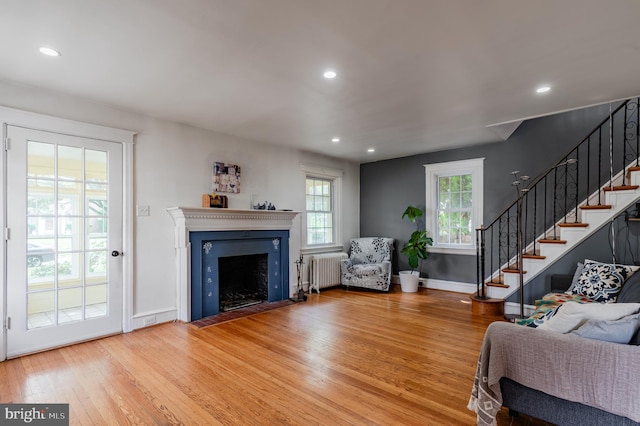 2416 Whitby Rd, Havertown, PA 19083 - living area featuring radiator, hardwood / wood-style flooring, stairs, a fireplace with flush hearth, and recessed lighting