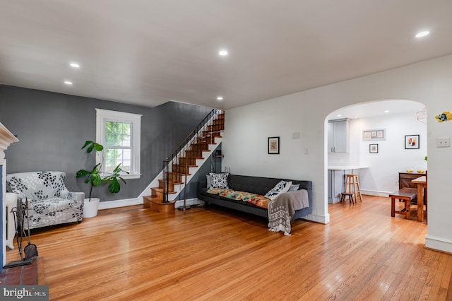 2416 Whitby Rd, Havertown, PA 19083 - living room featuring light wood-type flooring, arched walkways, stairway, and recessed lighting