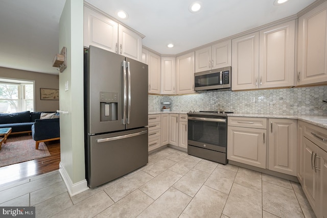 409 Chesterfield Dr, Downingtown, PA 19335 - kitchen featuring appliances with stainless steel finishes, recessed lighting, tasteful backsplash, light tile patterned floors, and light stone counters