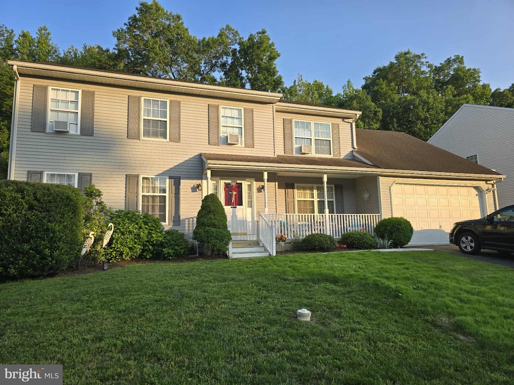 23 Deasy Dr, Newark, DE 19702 - view of front of property with a garage, a porch, and a front yard