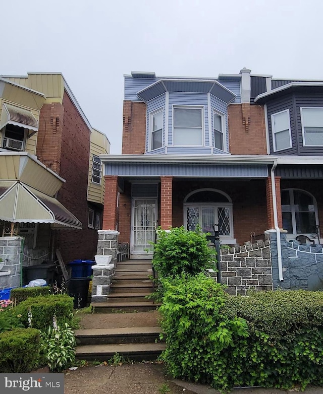 5642 Cedar Ave, Philadelphia, PA 19143 - view of front facade featuring covered porch and brick siding