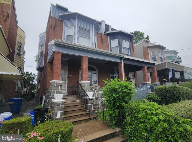 5642 Cedar Ave, Philadelphia, PA 19143 - view of front of house with a porch and brick siding