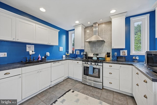 39 E 2nd Ave, Runnemede, NJ 08078 - kitchen with wall chimney range hood, appliances with stainless steel finishes, dark countertops, and white cabinetry