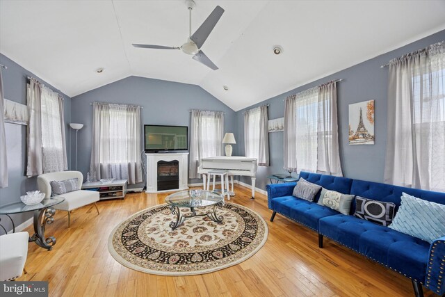 39 E 2nd Ave, Runnemede, NJ 08078 - living room featuring lofted ceiling, healthy amount of natural light, hardwood / wood-style flooring, a ceiling fan, and a glass covered fireplace