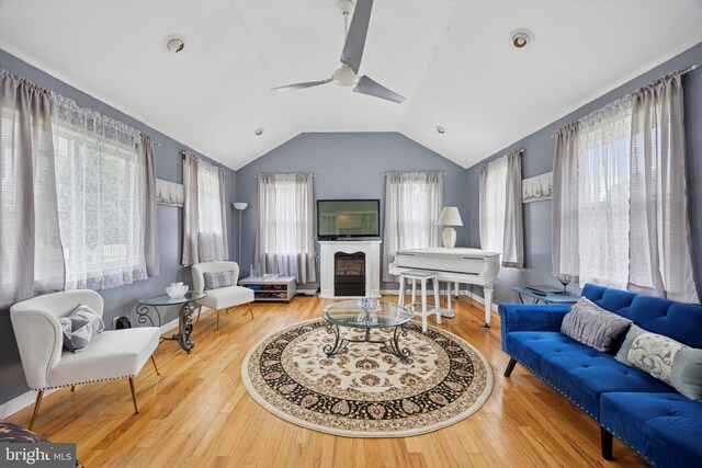 39 E 2nd Ave, Runnemede, NJ 08078 - living area featuring vaulted ceiling, ceiling fan, a glass covered fireplace, and wood finished floors