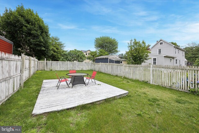 39 E 2nd Ave, Runnemede, NJ 08078 - fenced backyard with a wooden deck and outdoor dining area