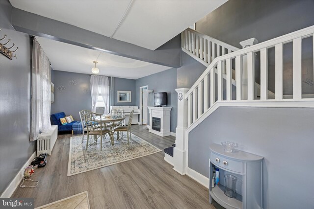 39 E 2nd Ave, Runnemede, NJ 08078 - dining room featuring radiator heating unit, stairway, and wood finished floors