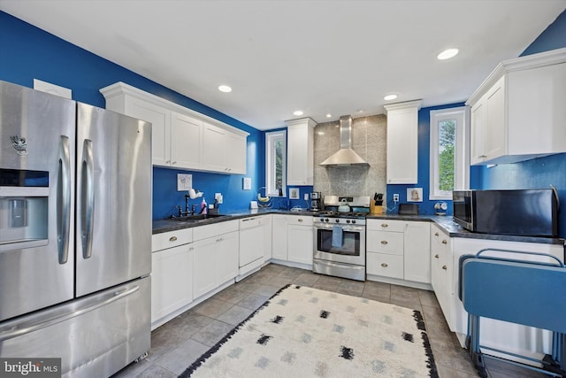 39 E 2nd Ave, Runnemede, NJ 08078 - kitchen with appliances with stainless steel finishes, wall chimney exhaust hood, backsplash, dark countertops, and recessed lighting