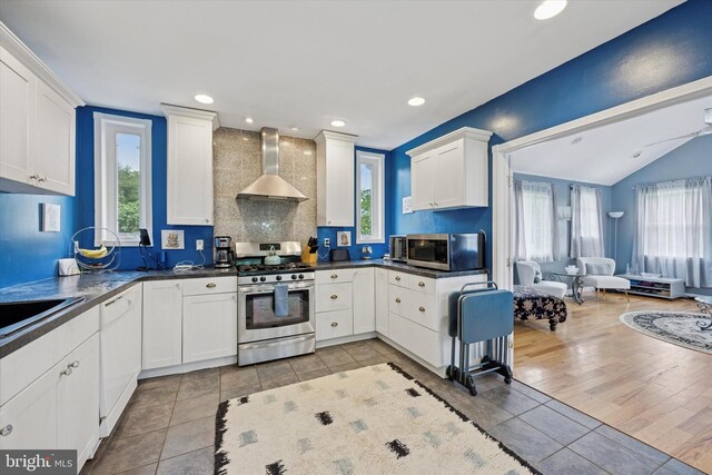 39 E 2nd Ave, Runnemede, NJ 08078 - kitchen with stainless steel appliances, wall chimney exhaust hood, healthy amount of natural light, white cabinets, and recessed lighting