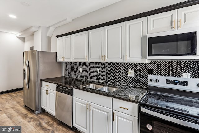 1820 Walbrook Ave, Baltimore, MD 21217 - kitchen with appliances with stainless steel finishes, white cabinets, and backsplash