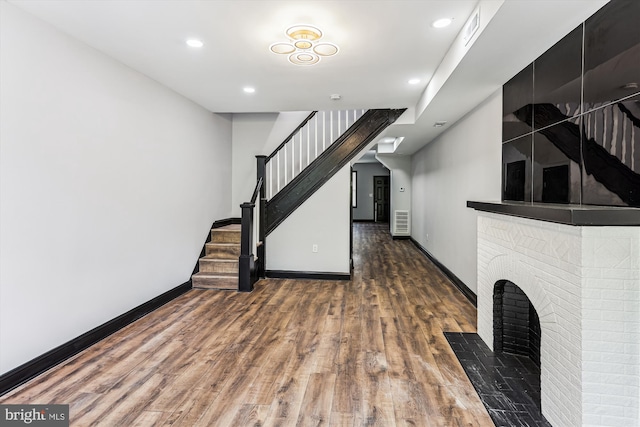 1820 Walbrook Ave, Baltimore, MD 21217 - unfurnished living room featuring wood finished floors, stairs, and recessed lighting