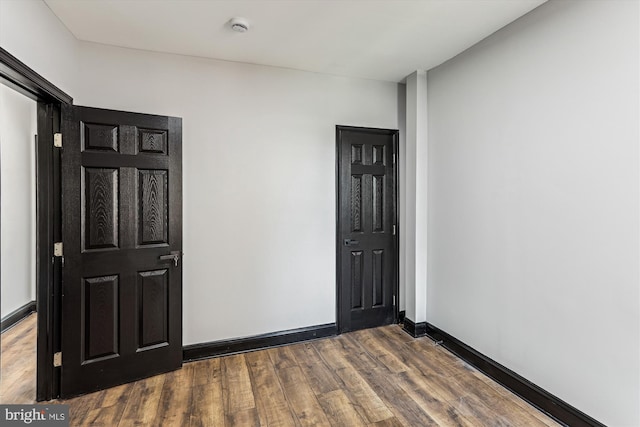 1820 Walbrook Ave, Baltimore, MD 21217 - spare room featuring a smoke detector and dark wood-type flooring