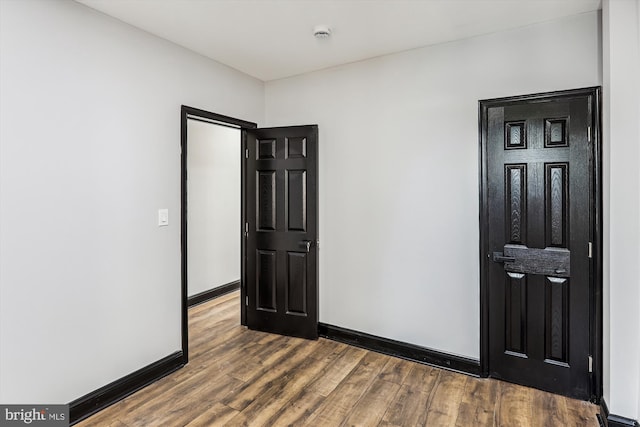 1820 Walbrook Ave, Baltimore, MD 21217 - spare room with dark wood-style floors and a smoke detector