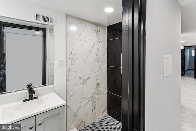 1820 Walbrook Ave, Baltimore, MD 21217 - bathroom with vanity, tiled shower, recessed lighting, and tile walls