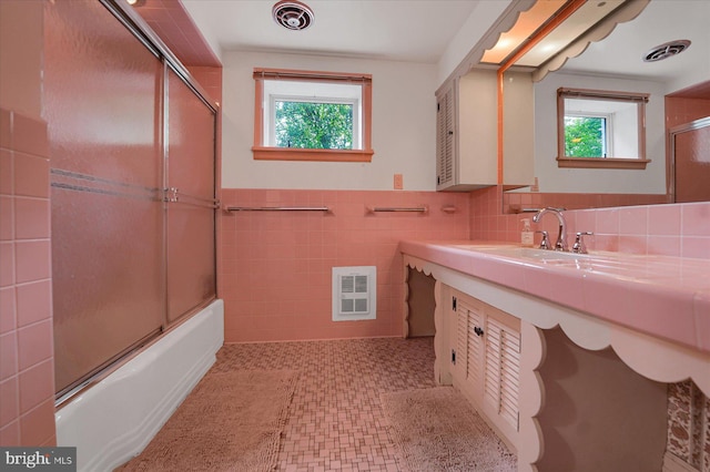 1304 Summit Dr, Bellefonte, PA 16823 - bathroom featuring plenty of natural light, combined bath / shower with glass door, vanity, tile walls, and tile patterned floors