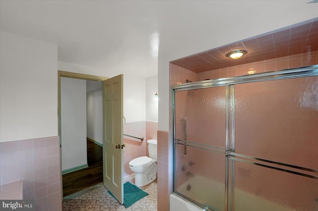1304 Summit Dr, Bellefonte, PA 16823 - full bathroom featuring tile walls, enclosed tub / shower combo, wainscoting, and tile patterned floors