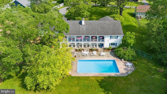 1304 Summit Dr, Bellefonte, PA 16823 - back of house featuring a balcony, a patio area, a fenced backyard, an outdoor pool, and a chimney