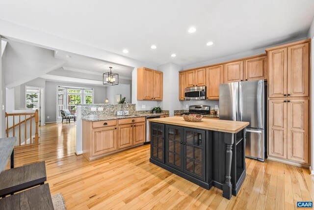 917 Bing Ln, Charlottesville, VA 22903 - kitchen with stainless steel appliances, light wood finished floors, a peninsula, wooden counters, and recessed lighting