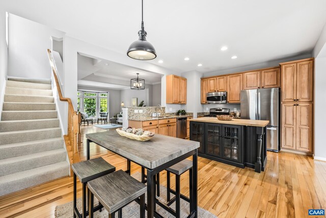 917 Bing Ln, Charlottesville, VA 22903 - kitchen with stainless steel appliances, light wood-style floors, recessed lighting, pendant lighting, and a center island