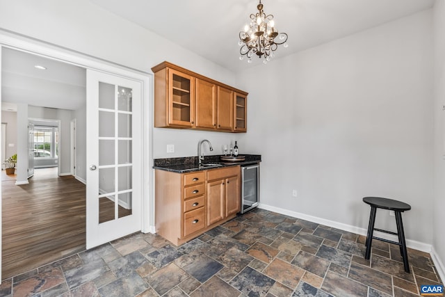 917 Bing Ln, Charlottesville, VA 22903 - indoor wet bar with beverage cooler, a chandelier, dark stone finish floors, and pendant lighting