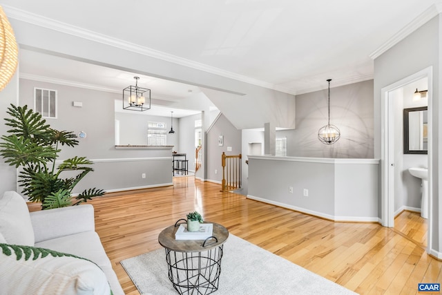 917 Bing Ln, Charlottesville, VA 22903 - living room featuring a chandelier, wood finished floors, and crown molding