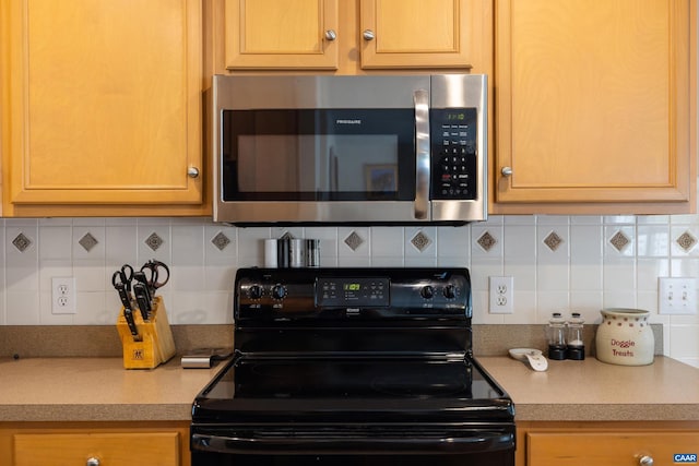 82 Peterson Pl, Fishersville, VA 22939 - kitchen with black electric range oven, stainless steel microwave, tasteful backsplash, and light countertops