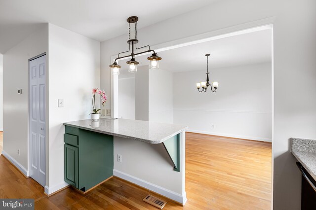 4 Beaver Pond Cir, Baltimore, MD 21234 - kitchen featuring green cabinetry, light wood-style floors, a chandelier, and light stone countertops
