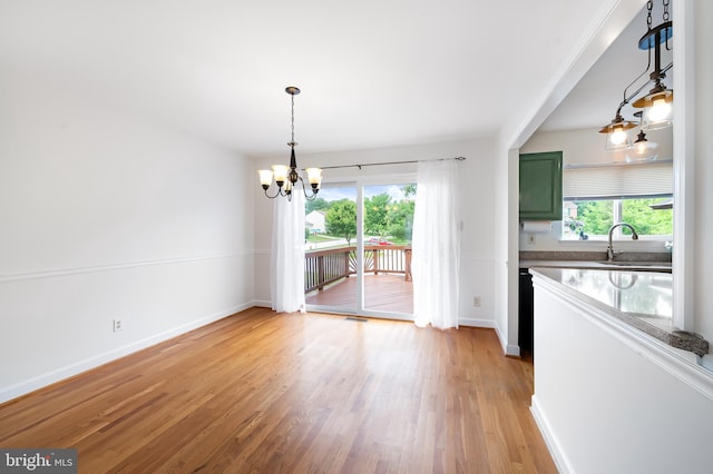 4 Beaver Pond Cir, Baltimore, MD 21234 - unfurnished dining area featuring a chandelier and light wood-type flooring