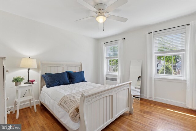 1417 Dorset Ln, Wynnewood, PA 19096 - bedroom with light wood-style flooring, radiator, and ceiling fan