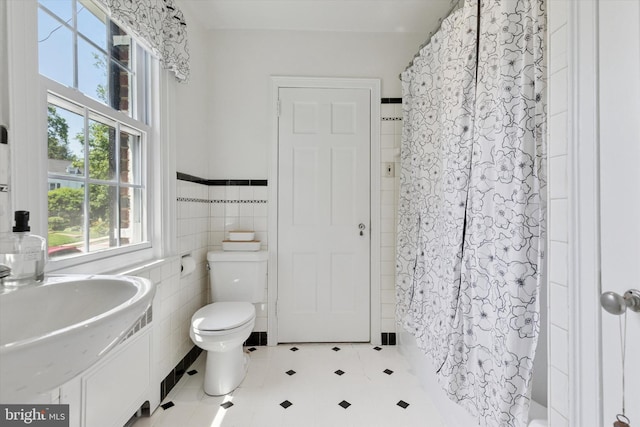 1417 Dorset Ln, Wynnewood, PA 19096 - full bathroom featuring tile walls, shower / tub combo with curtain, and a wainscoted wall