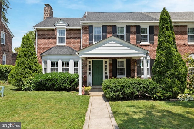 1417 Dorset Ln, Wynnewood, PA 19096 - view of front of property with a chimney, a front yard, and brick siding